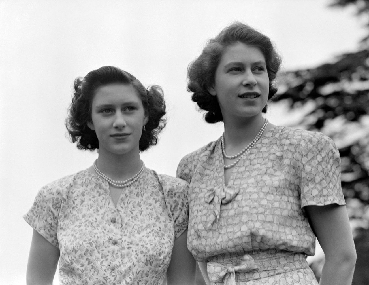 Elizabeth, right, and Princess Margaret wear summer dresses circa 1942. Margaret was Elizabeth's only sibling.