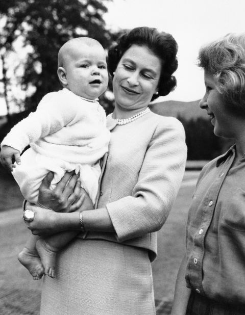 The Queen holds her son Prince Andrew while his sister, Princess Anne, watches during a family holiday at Scotland's Balmoral Castle in September 1960. The Queen has four children, including sons Charles and Edward.