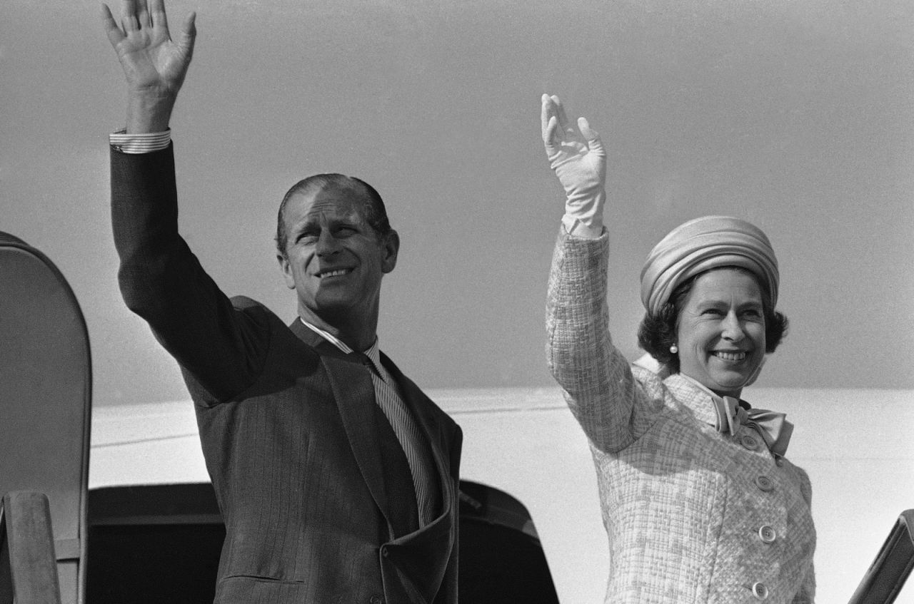 The Queen and Prince Philip wave from a plane ramp shortly before taking off from Tokyo in May 1975.