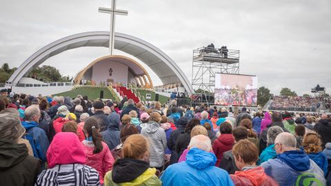 People celebrate Mass in Dublin's Phoenix Park, braving wet and windy weather.