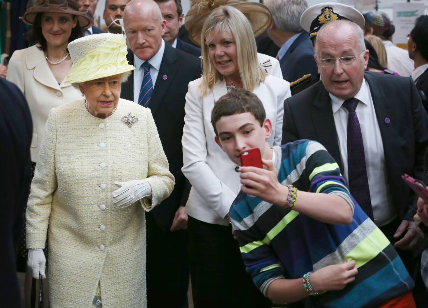 A boy in Belfast, Northern Ireland, takes a selfie in front of the Queen in June 2014.