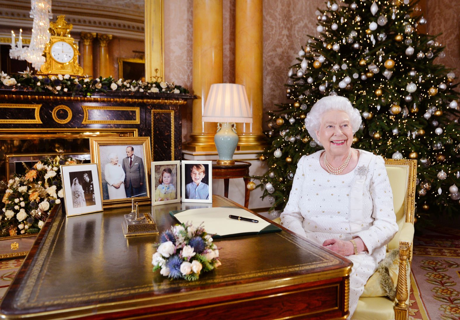 The Queen sits at a desk in Buckingham Palace after recording her Christmas Day broadcast in 2017.