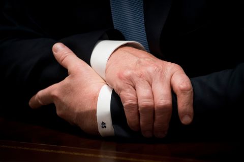 A close-up of Trump's shirt cuff reads "45" as he speaks during a Cabinet meeting in June 2018.