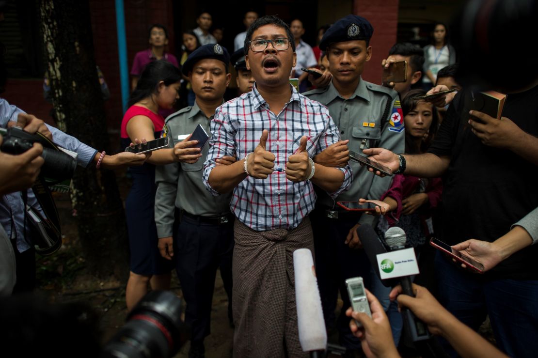 Detained Reuters journalist Wa Lone speaks to journalists after appearing before a court trial in Yangon in August 2018.
