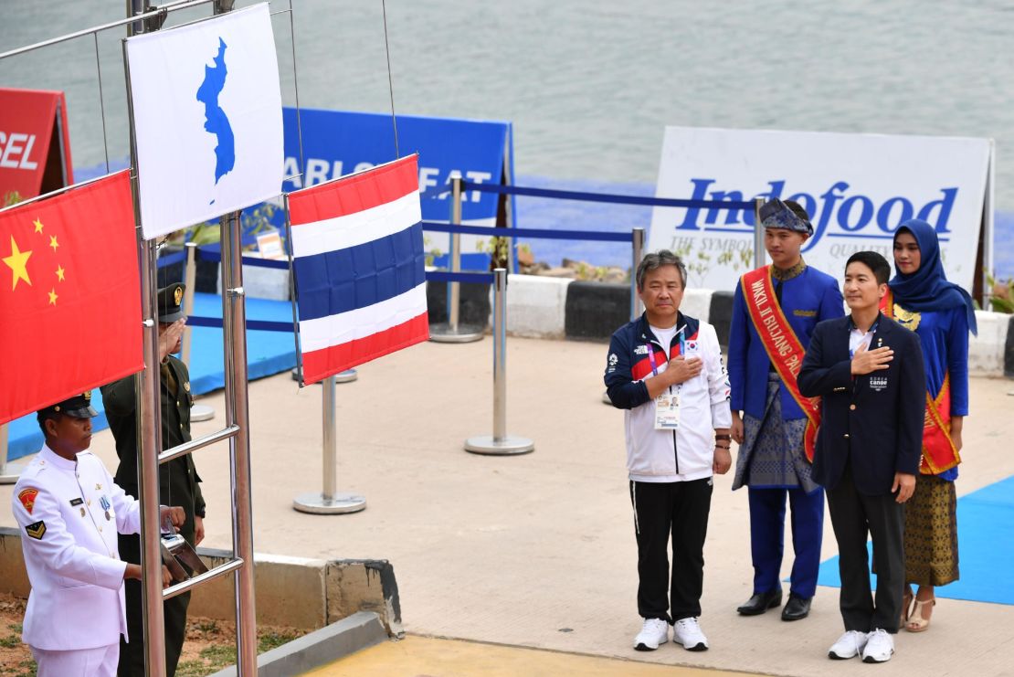 The flag of gold medalists Unified Korea is displayed next to silver medalists China and bronze medalists Thailand during the medals ceremony.