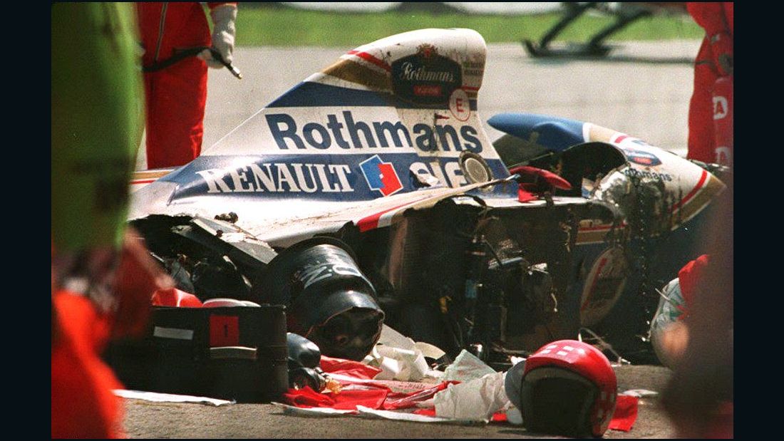 Security personnel surround the crashed car of Brazilian Formula One driver Ayrton Senna.