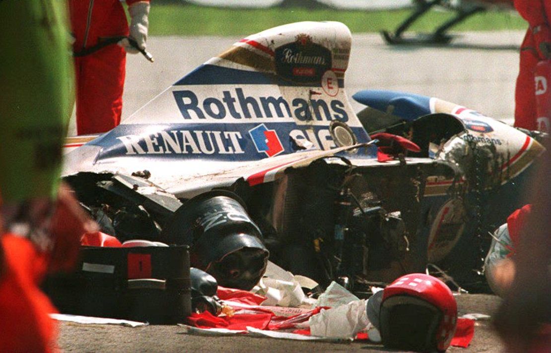 Security personnel surround the crashed car of Brazilian Formula One driver Ayrton Senna.