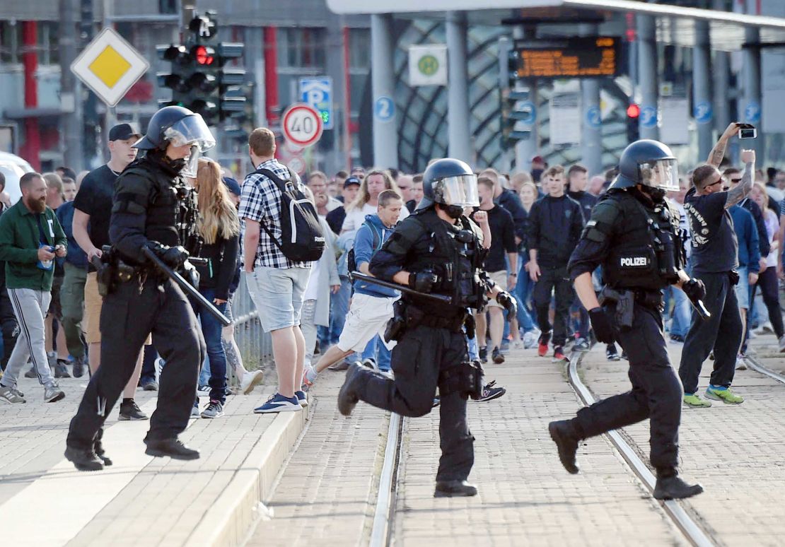 Riot police run in Chemnitz on Sunday as far-right protesters march in the streets.