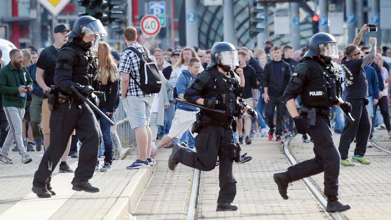 Riot police run in Chemnitz on Sunday as far-right protesters march in the streets.