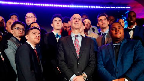 NBA Commissioner Adam Silver, center, poses with gamers at the NBA 2K League Draft in April 2018. 