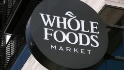 Signage hangs on display outside a Whole Foods Market Inc. location in Burbank, California, U.S., on Wednesday, June 20, 2018. Customer traffic was up 2.4 percent at Whole Foods stores during the first five months of 2018, a sign that Amazon has managed to draw in new shoppers with ballyhooed price cuts on a handful of items. Photographer: Dania Maxwell/Bloomberg via Getty Images