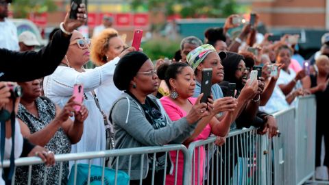 People photograph the casket containing Aretha Franklin as it arrives at the Charles H. Wright Museum of African American History. Crowds were told no photography would be allowed inside.