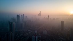 TOPSHOT - This overhead photo shows the sun rising above the skyline of Shanghai on a polluted day on February 23, 2018. / AFP PHOTO / Johannes EISELE        (Photo credit should read JOHANNES EISELE/AFP/Getty Images)