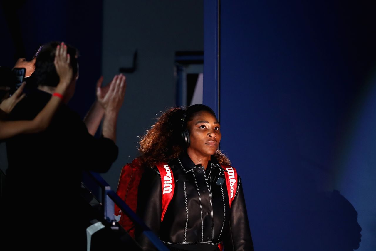 Williams, playing her first home Slam since giving birth to her first child last year, entered the Arthur Ashe Stadium in a black bomber jacket with white trim.  