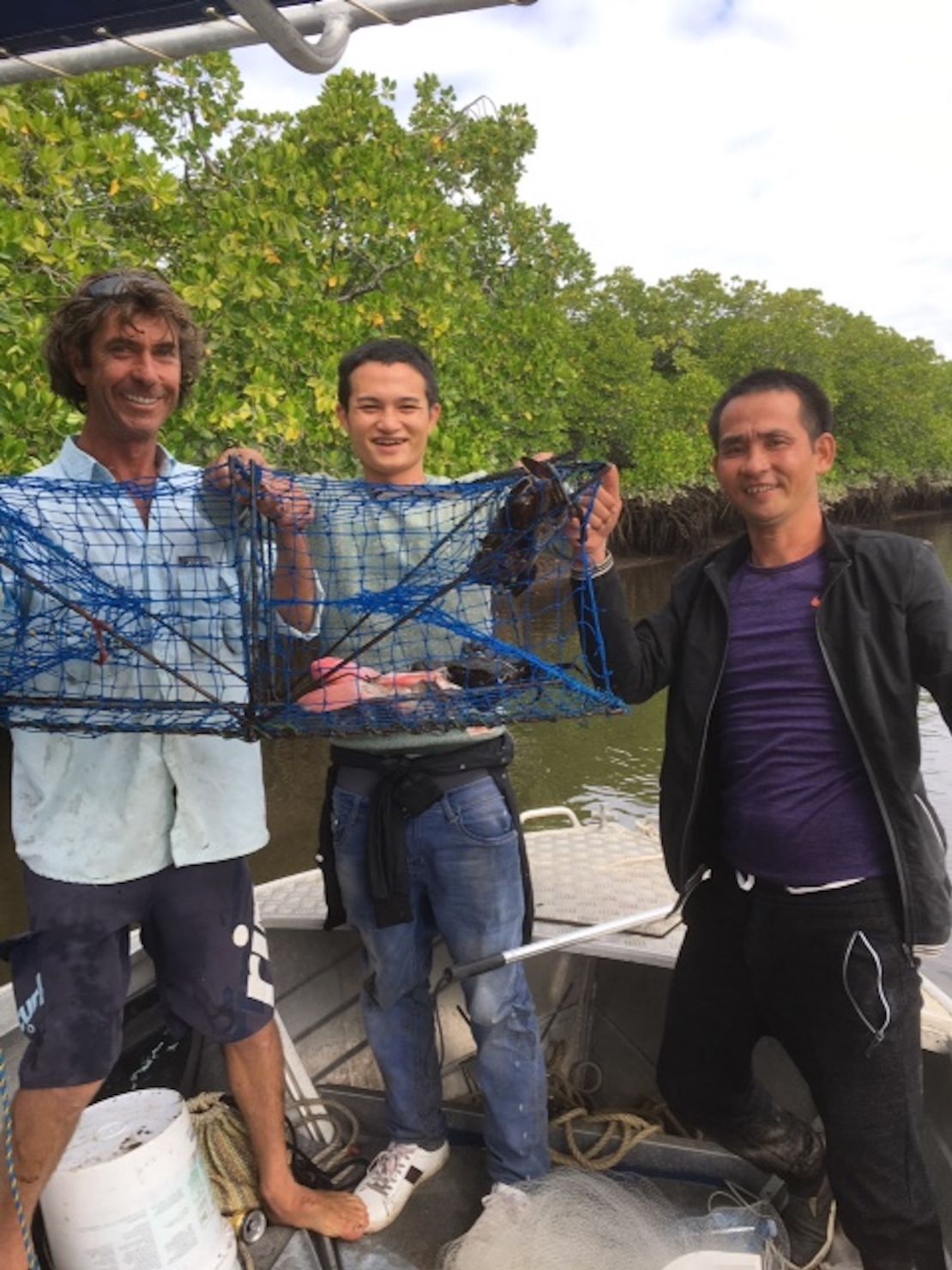 Preston holds up a crab pot with the two men he and Justin Ward picked up on the Daintree River.