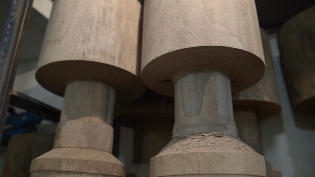 The walnut logs are cut into the tonbak's traditional goblet shape. 