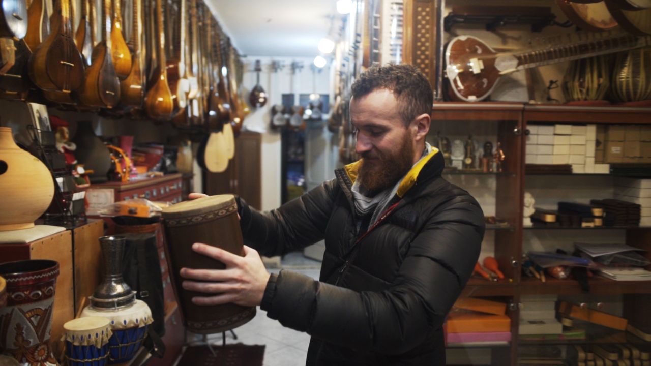 Browsing the Iranian classical instruments on sale in a Tehran shop.