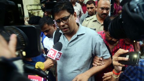 Activist Arun Ferreira speaks to the media as he is arrested by policemen in Thane, India, on Tuesday.