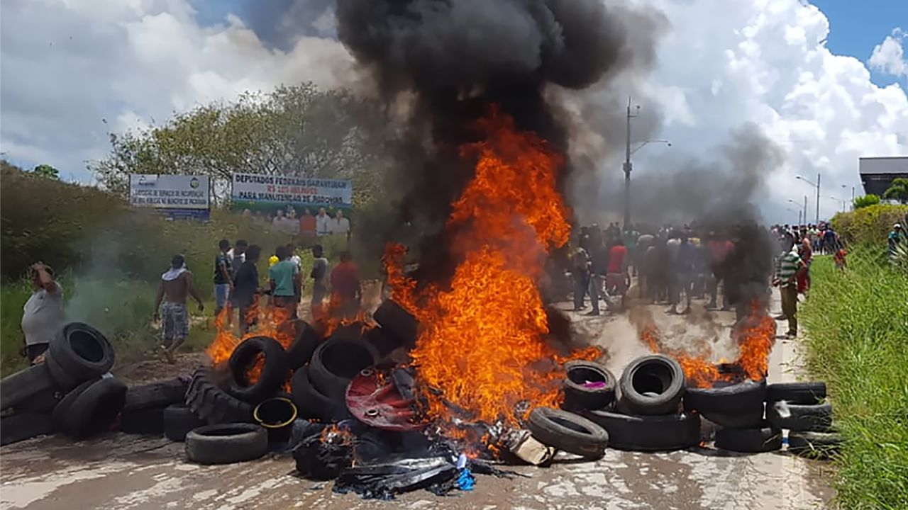 Residents of the Brazilian border town of Pacaraima burn tires and belongings of Venezuelans immigrants after attacking their two main makeshift camps, leading them to cross the border back into their home country earlier in August.
