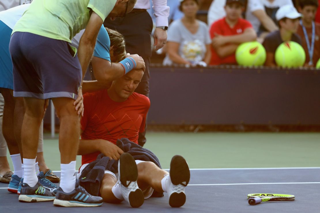 Mikhail Youzhny of Russia struggling with heat exhaustion during his first round match against Marcos Baghdatis of Cyprus at the US Open. 