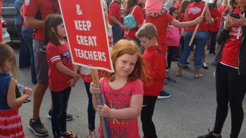 Monroe High School teacher Scott Darrow posted this image of his daughter at a protest earlier this week. The Monroe school year is supposed to start Wednesday.