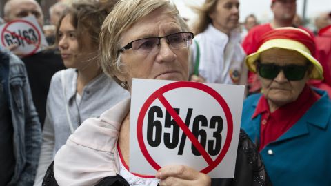A woman holds a poster protesting an increase in the pension ages from the current 60 to 65 for men and from 55 to 63 for women during a rally in Moscow on August 21.