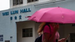 A student walks in front of University of Hong Kong's Wei Lun Hall, the residential block where university professor Cheung Kie-chung and his family lived, in Hong Kong's Pok Fu Lam area on August 29, 2018. - A University of Hong Kong professor has been arrested on suspicion of killing his wife after police found a body stuffed into a suitcase in his office, the latest grisly murder to transfix the crowded city. (Photo by Philip FONG / AFP)        (Photo credit should read PHILIP FONG/AFP/Getty Images)