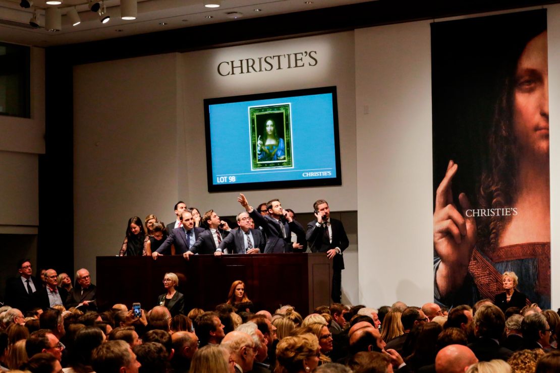 Agents speak on their phones with their clients while bidding on at the auction of Leonardo da Vinci's "Salvator Mundi" during the sale at Christie's on Nov. 15, 2017 in New York. The rediscovered masterpiece  sold for an historic $450M, obliterating the previous world record for the most expensive work of art at auction.