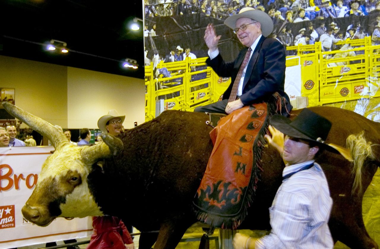 Buffett sits atop a fake bull at the Berkshire Hathaway annual meeting in 2006.