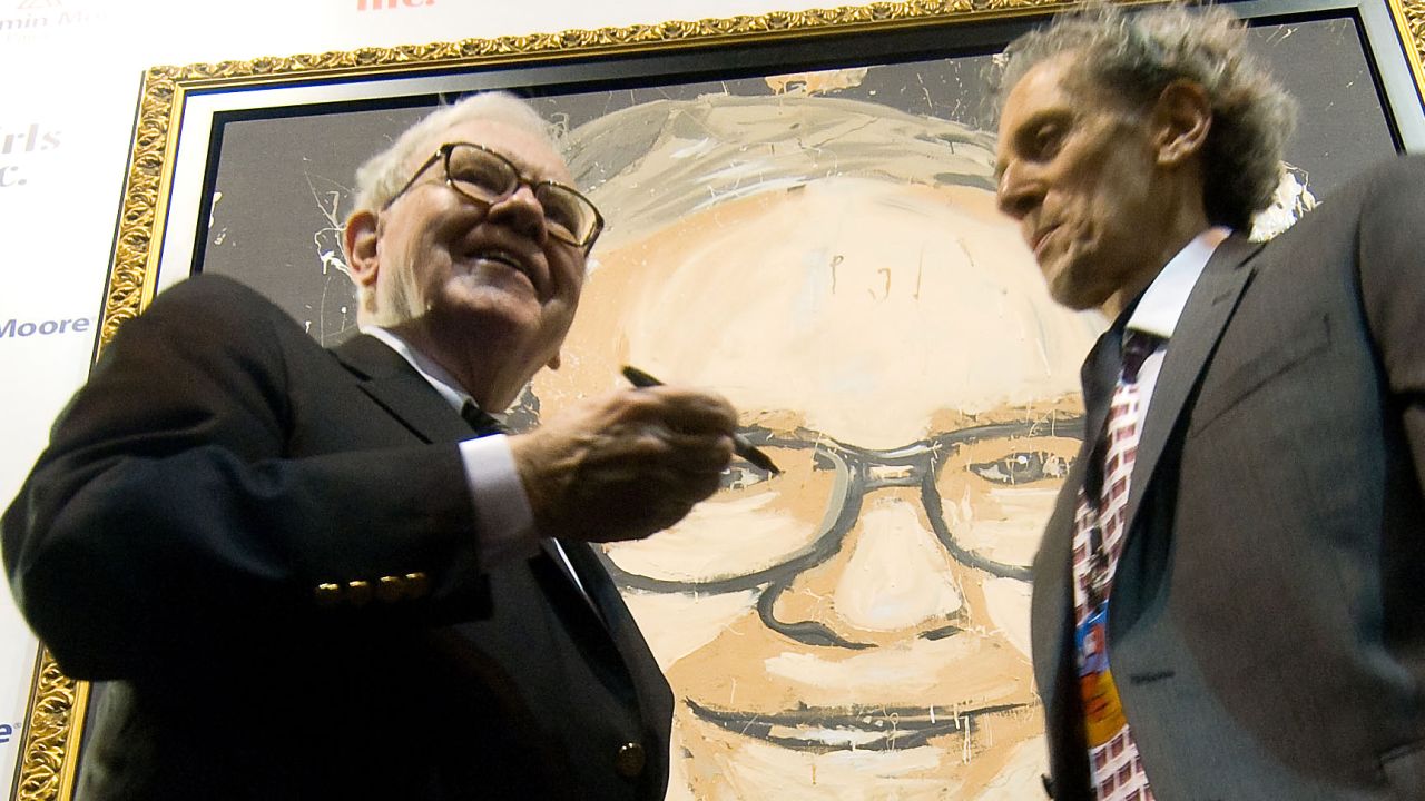 Buffett stands in front of a portrait of himself, painted by Michael Israel, in 2008.