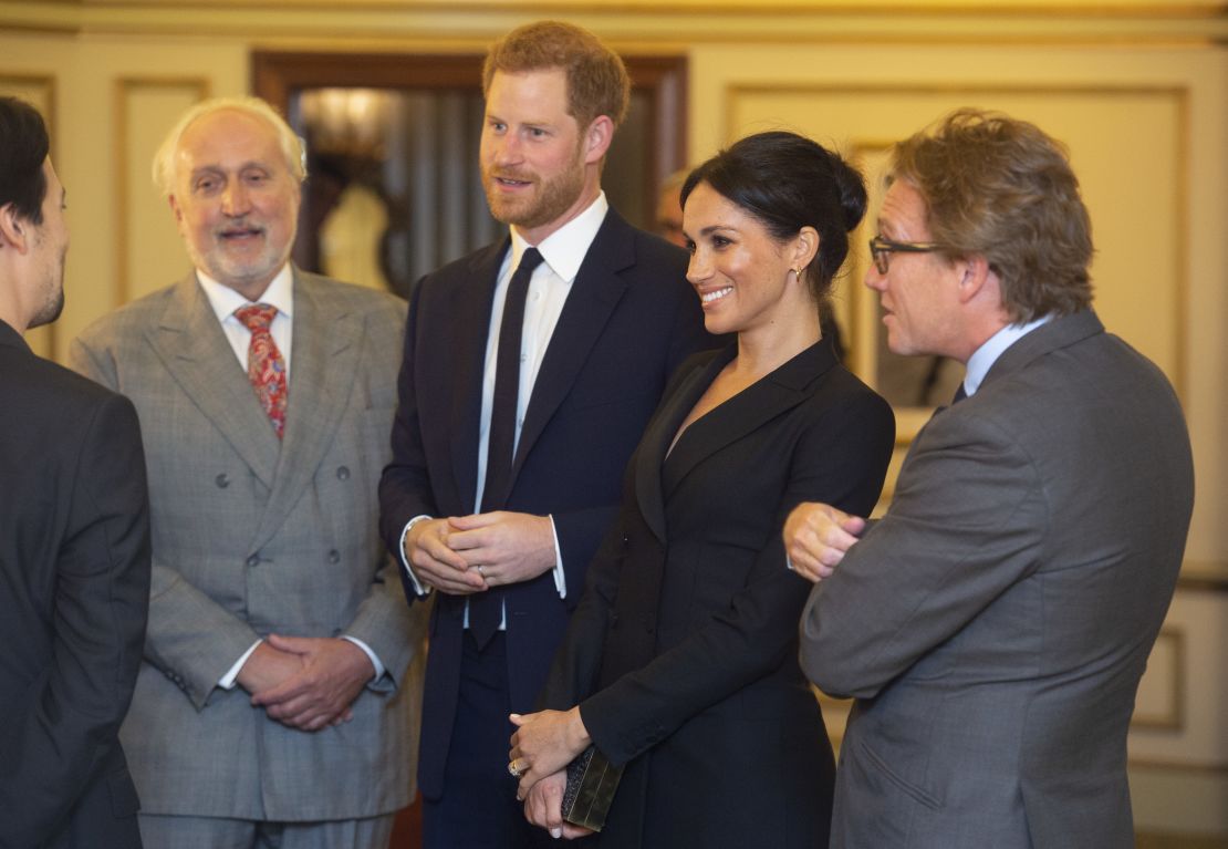 Harry and Meghan speak with Miranda and officials from the Sentebale charity.