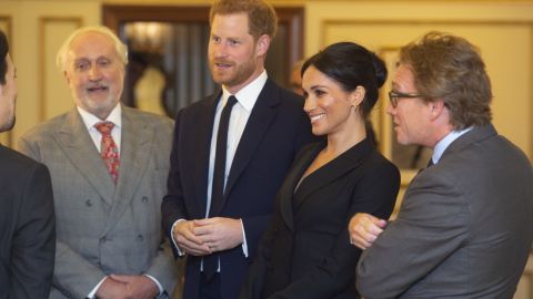Harry and Meghan speak with Miranda and officials from the Sentebale charity.