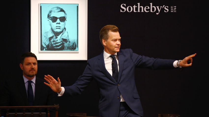 Oliver Barker, Sotheby's European Chairman, fields bids for Andy Warhol's "Self Portrait" from 1963-64, during the Contemporary Art Evening Auction at Sotheby's on June 28, 2017 in London, England.