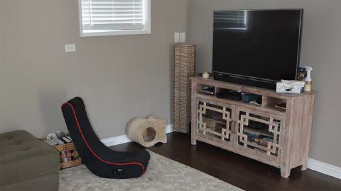 A rocking chair sits in front of a television in the Hart family's home.