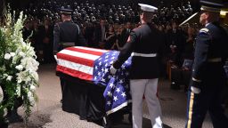 The flag-draped casket of the late US Senator John McCain arrives at the North Phoenix Baptist Church for the memorial service honoring McCain, August 30, 2018 in Phoenix, Arizona. (Photo by Robyn Beck / AFP)        (Photo credit should read ROBYN BECK/AFP/Getty Images)