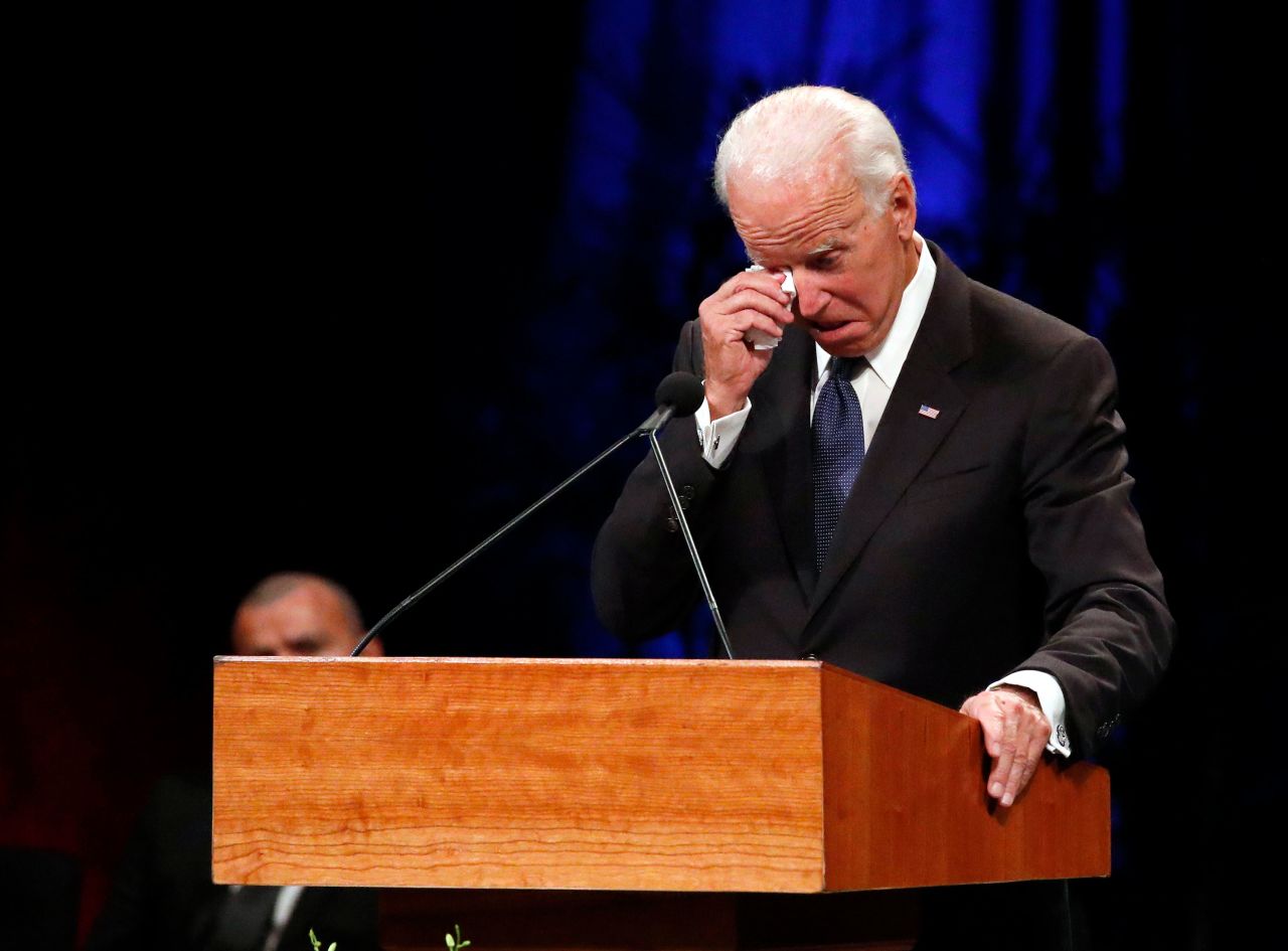 Former Vice President Joe Biden wipes away a tear while giving a tribute to McCain at Thursday's memorial service in Phoenix. "I always thought of John as a brother," Biden said. "We had a hell of a lot of family fights. We go back a long way."