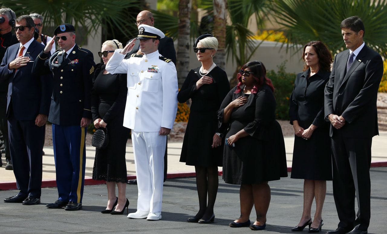 McCain's family watches as his casket is moved from a hearse on Thursday. From left are McCain's son Doug, his son Jimmy, his daughter Meghan, his son Jack, his wife Cindy, his daughter Bridget, his daughter Sidney and his son Andrew.