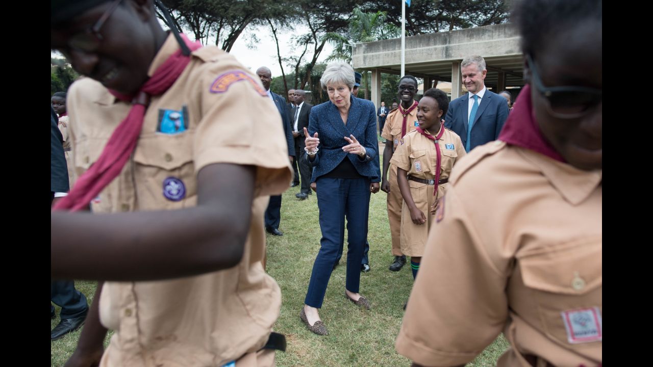 British Prime Minister Theresa May breaks into dance while meeting with UN scouts in Nairobi, Kenya, on Thursday, August 30.