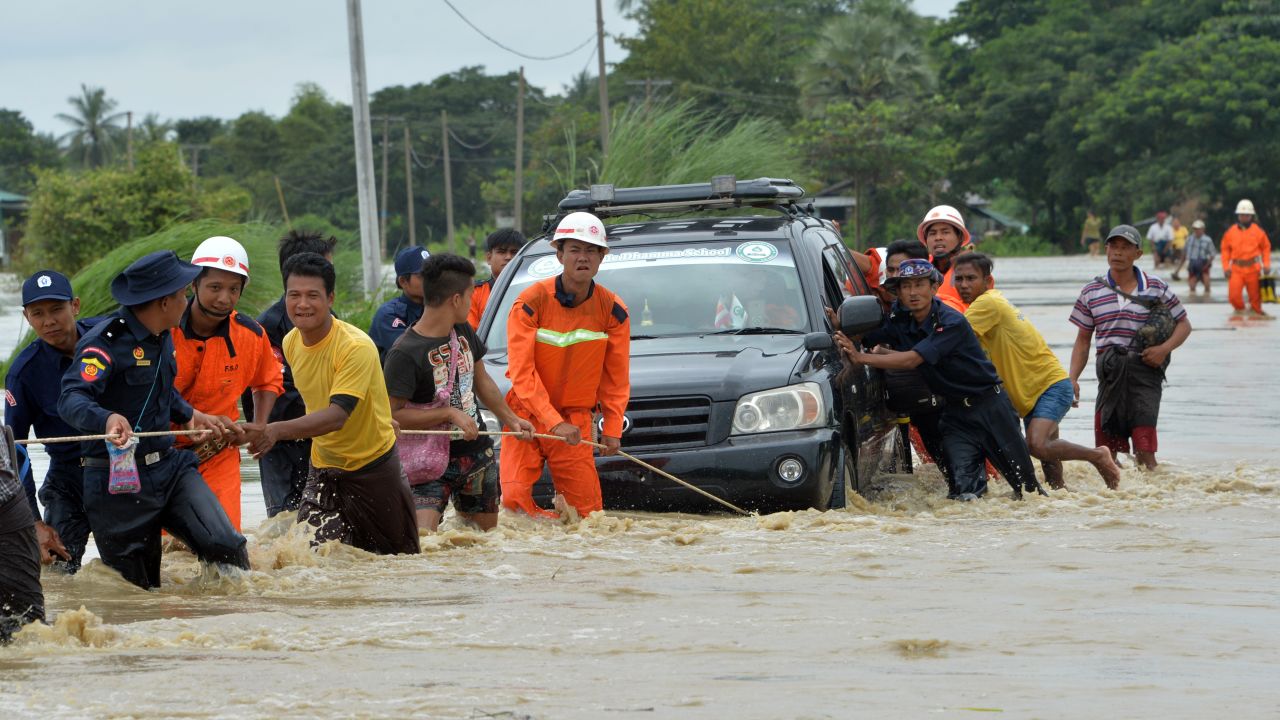 Local residents negotiate a flooded road after <a href="https://www.cnn.com/2018/08/29/asia/myanmar-dam-breach-intl/index.html" target="_blank">a dam collapsed</a> in Myanmar's Bago region on Wednesday, August 29.