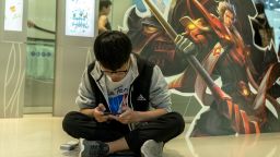 TIANJIN, CHINA - 2017/10/01: Young players practice the mobile game Arena of Valor, prepared for the battle match held in a shopping mall.  Arena of Valor: 5v5 Arena Game, China's most popular mobile game developed by Tencent Inc, which is the world's largest mobile games developer.  In the first half of 2017, the sales of China's online game market reached 99.78 billion yuan, of which the revenue from mobile games industry arrived at 56.2 billion yuan, ranking first in the world. (Photo by Zhang Peng/LightRocket via Getty Images)