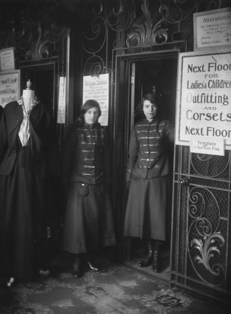 Two female lift operators on duty beside the lifts at Swan & Edgar's department store, London, 1916.