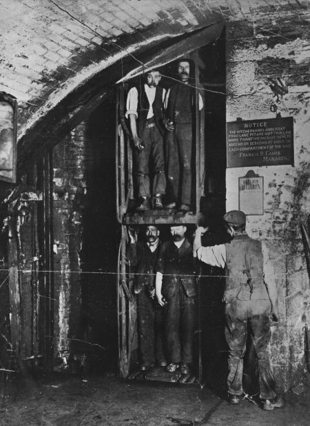 Miners going up in the lift at the end of their shift around the year 1900.