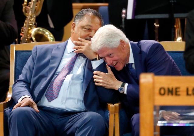 Former President Bill Clinton talks with the Rev. Jesse Jackson on Friday.