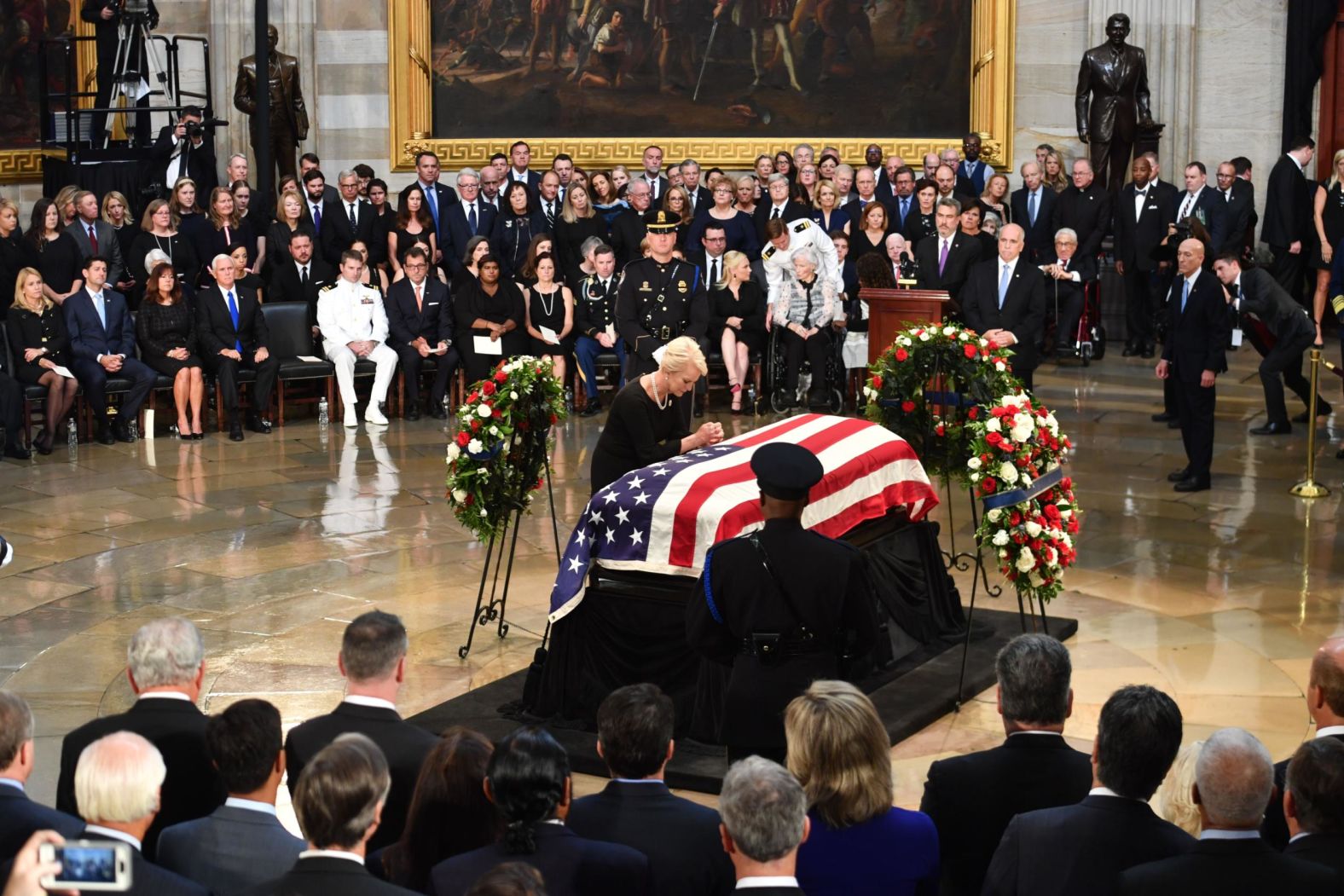 Cindy McCain prays at her husband's casket on Friday.