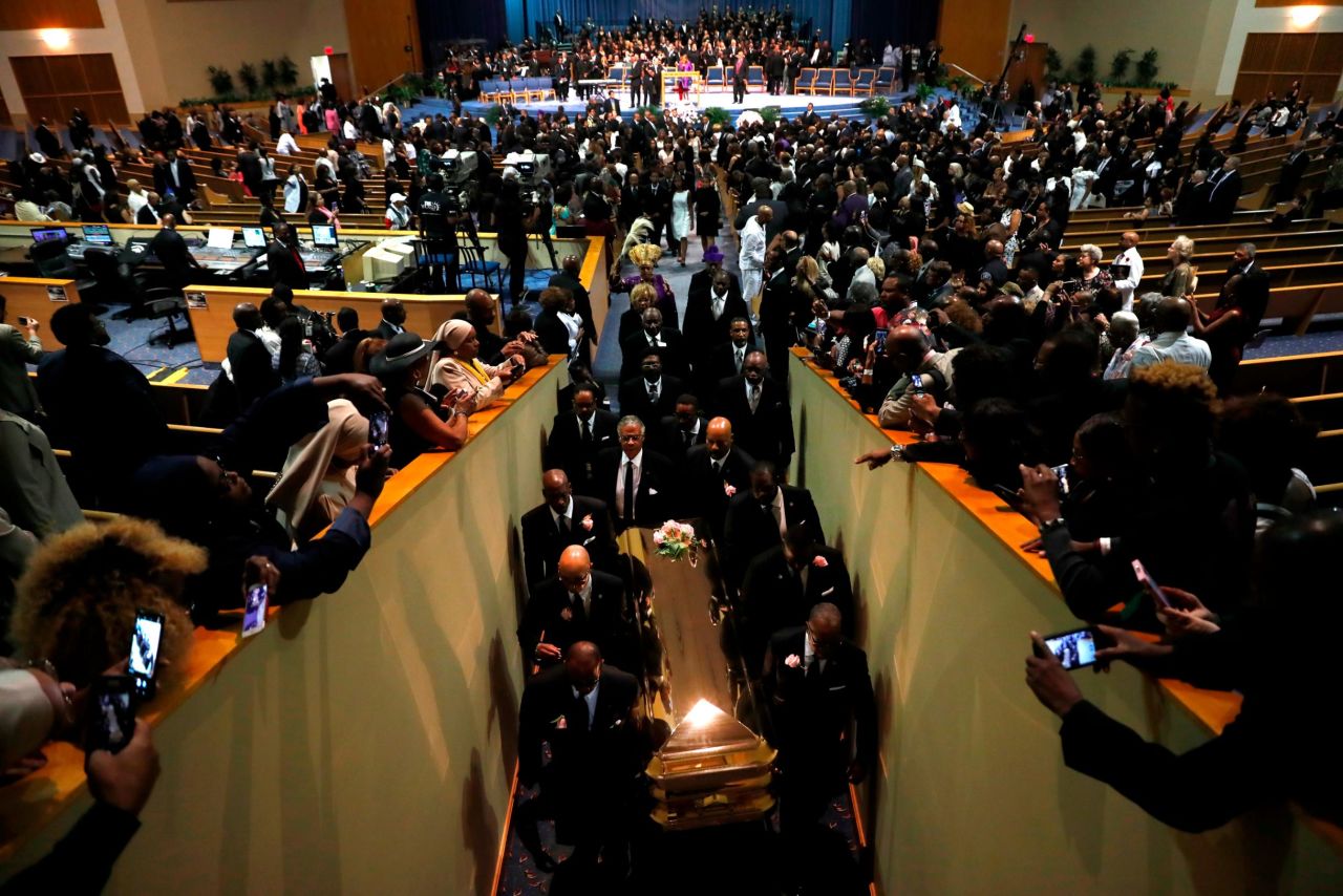 Pallbearers carry Franklin's casket out of Greater Grace Temple at the end of her funeral service on Friday. Mourners made their way through the center of the church as Jennifer Holliday and the Aretha Franklin Celebration Choir performed Franklin's hit "Climbing Higher Mountains."