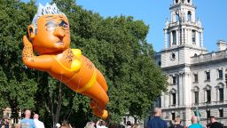 People watch as an inflatable caricature balloon of Mayor of London, Sadiq Khan is released over Parliament Square in London, Saturday, Sept. 1, 2018. Organizer Yanny Bruere raised more than 58,000 pounds ($75,000) through the Crowdfunder website for the 29-foot (8.8-meter) blimp as part of a campaign to oust Khan from his post. Khan angered some people in the British capital and elsewhere last month when he allowed a balloon caricaturing Donald Trump as an angry baby to float above the city while the U.S. president was in England. (AP Photo/Nishat Ahmed)