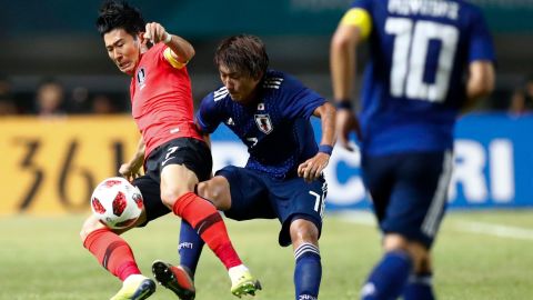South Korea's Son Heung-min, left, duels for the ball against Japan's Teruki Hara during Saturday's match.