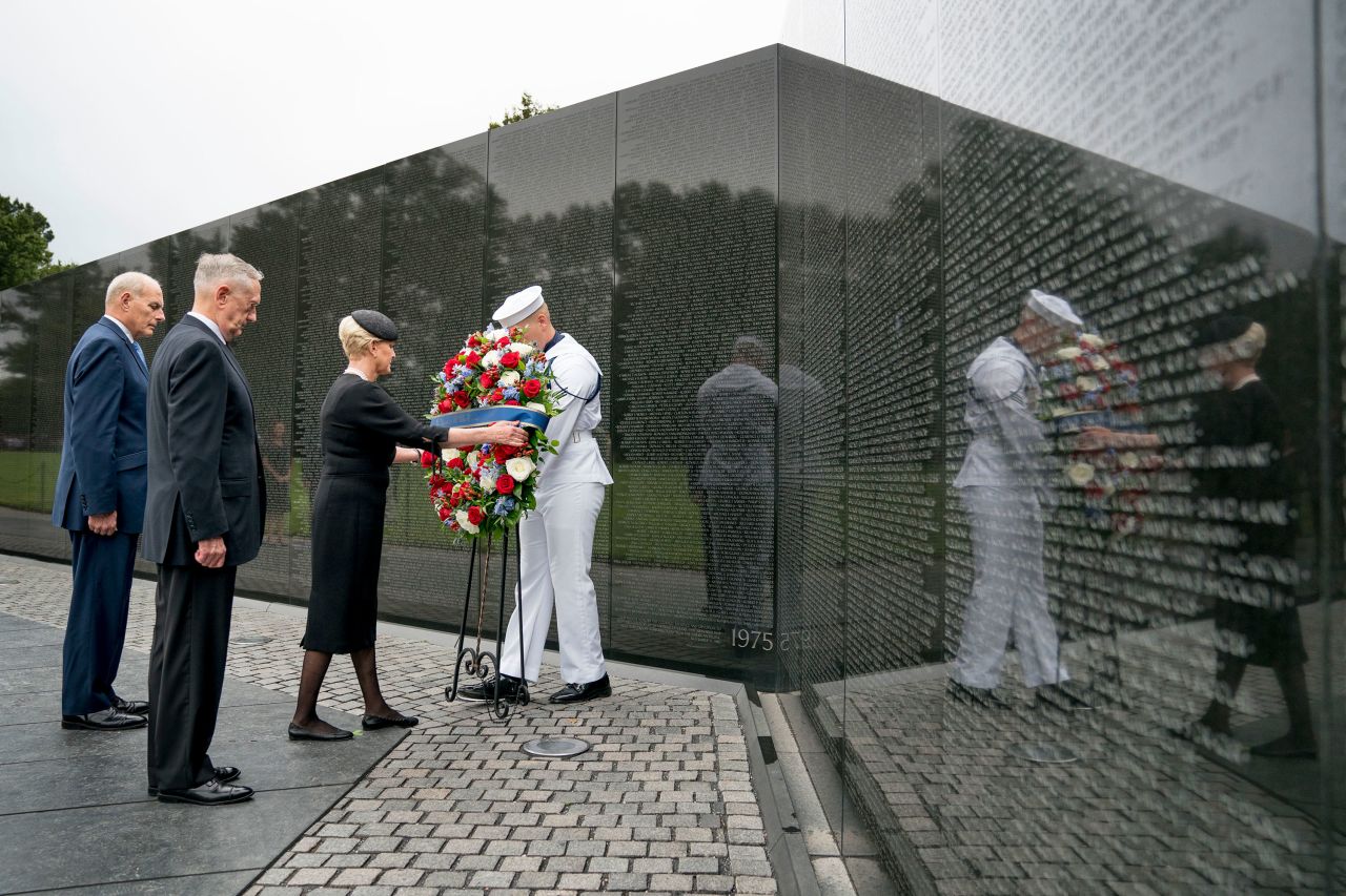 Cindy McCain is accompanied by White House Chief of Staff John Kelly, left, and Defense Secretary Jim Mattis as she lays a wreath at the Vietnam Veterans Memorial on Saturday.