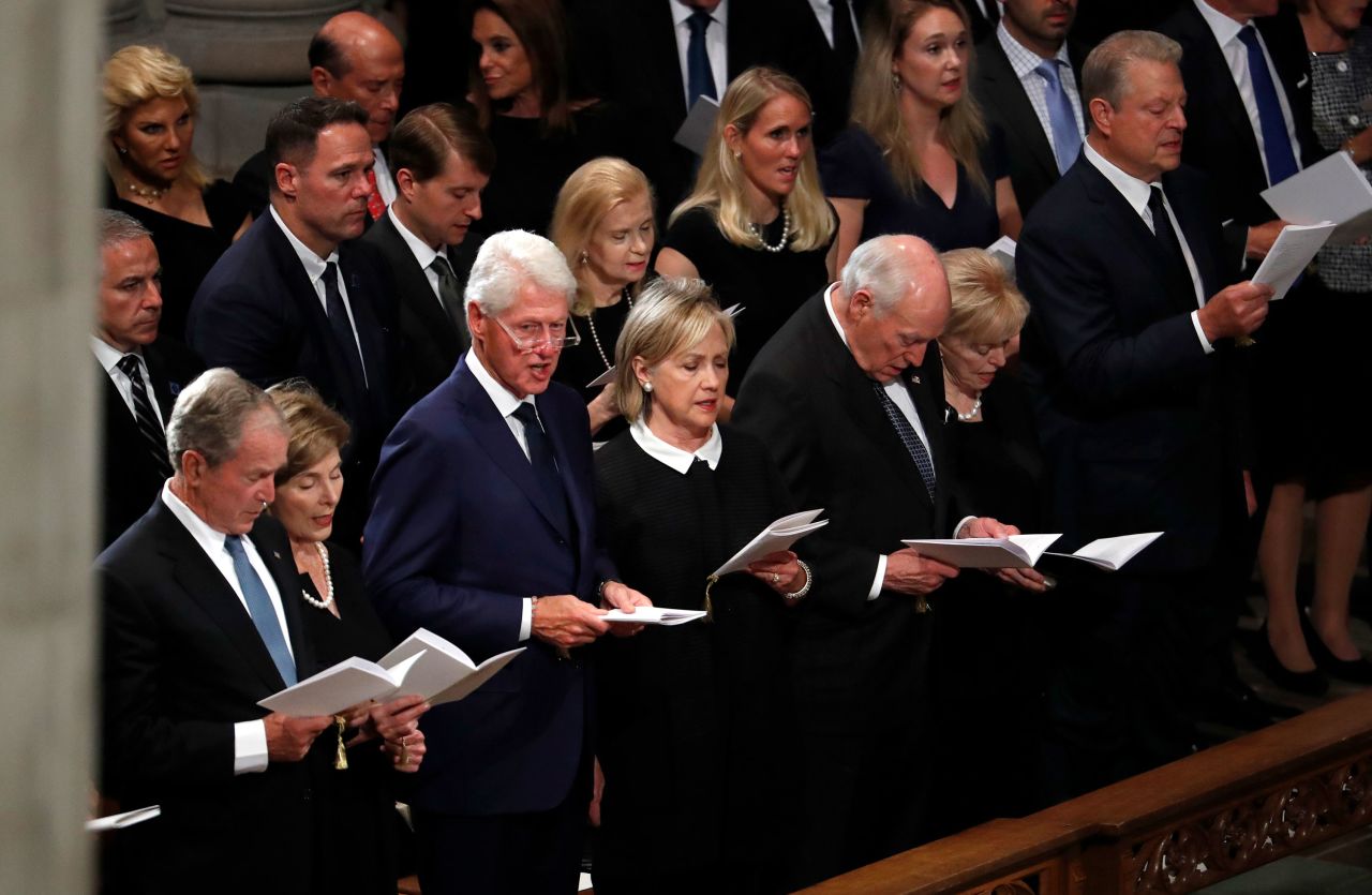 From left, former President George W. Bush; former first lady Laura Bush; former President Bill Clinton; former Secretary of State Hillary Clinton; former Vice President Dick Cheney; Cheney's wife, Lynne; and former Vice President Al Gore sing during the memorial service Saturday.