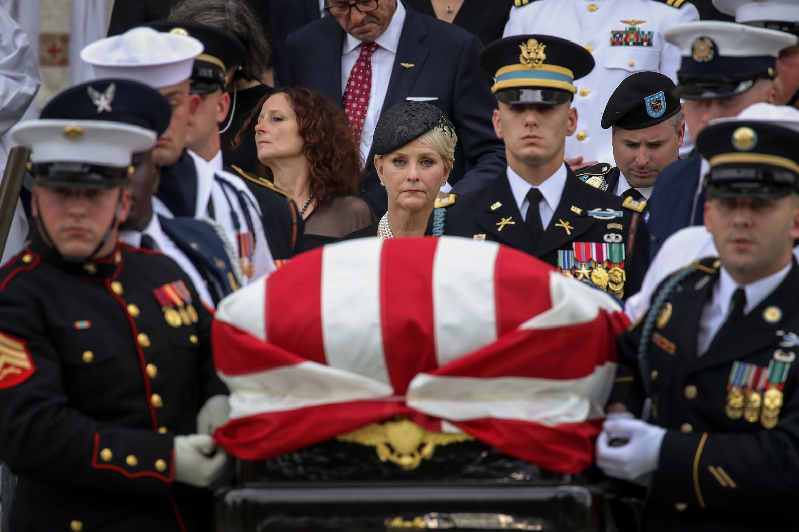 Cindy McCain looks on as her husband's casket is carried after a funeral service Saturday at the Washington National Cathedral.